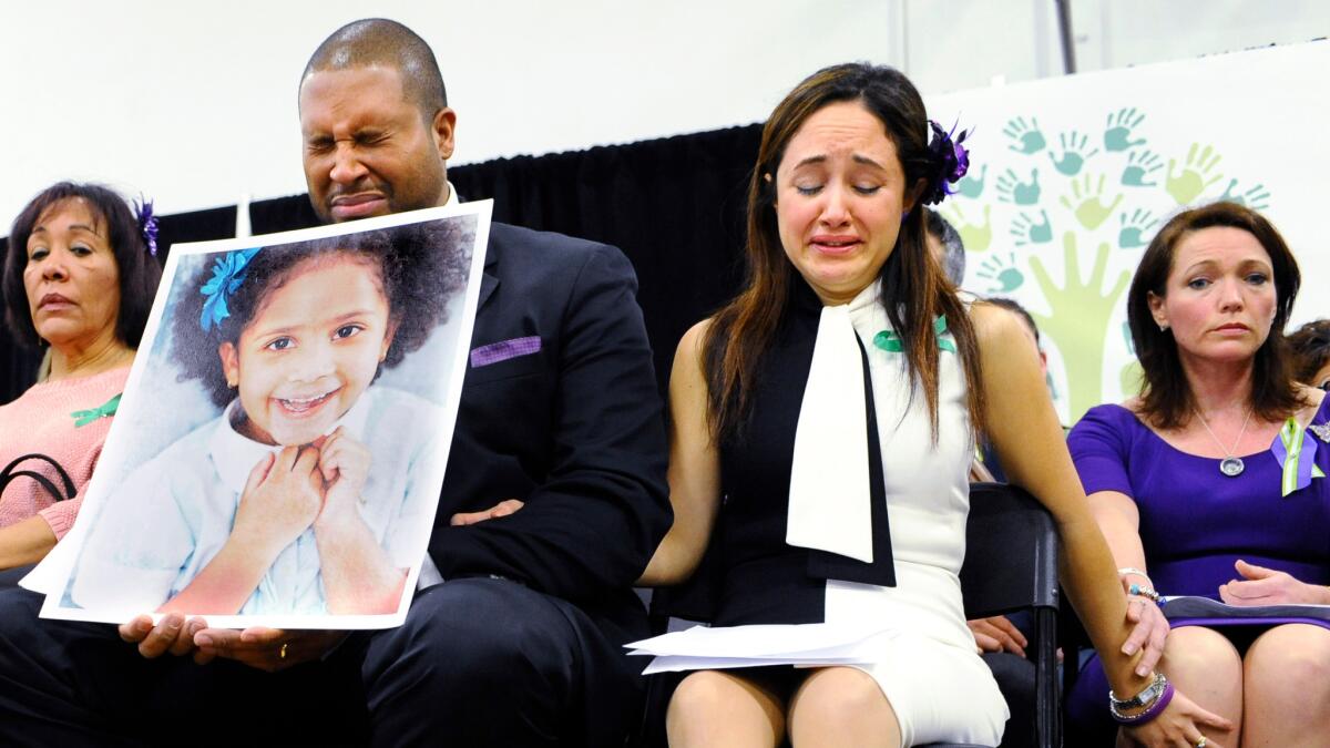 Nelba Marquez-Greene and her husband with a picture of their daughter, Ana Grace.