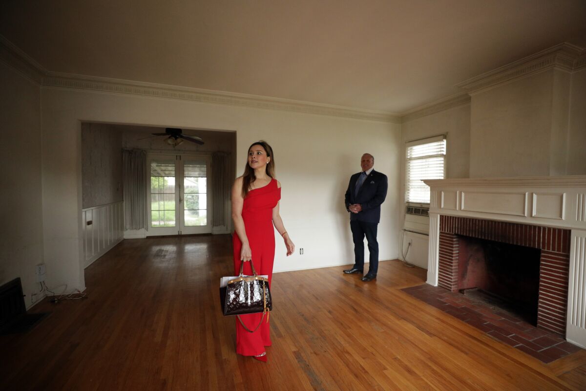 Real estate investor Celine Yan and her agent, Jeff Brager, look over a North Hollywood house she is purchasing. 