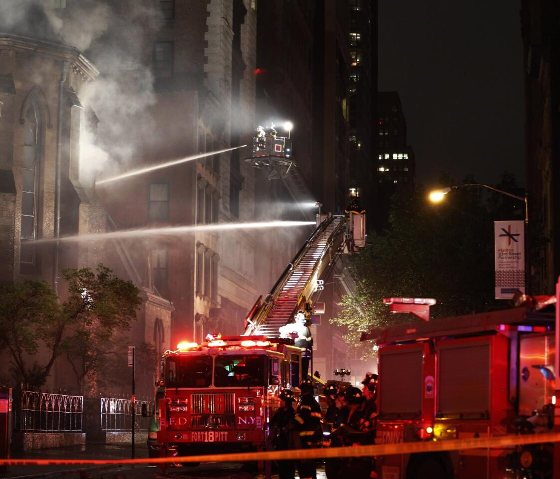 Firefighters battle a three-alarm fire in the historic Serbian Orthodox Cathedral of St. Sava in Sunday, May 1, 2016, in New York.