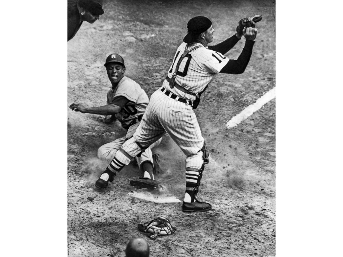 Maury Wills scores from first base on fourth-inning double by Johnny Podres in Game 6 of the 1959 World Series.