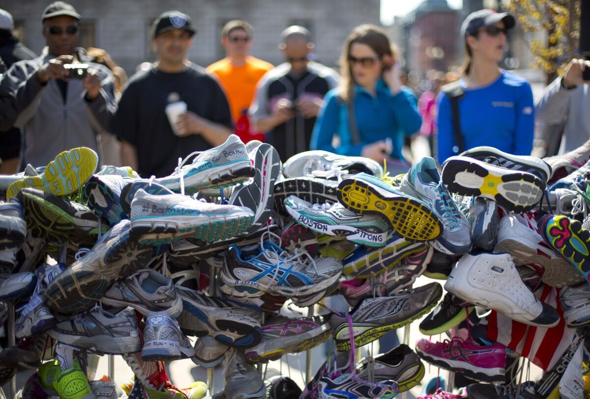 A collection of running shoes are part of a makeshift memorial honoring the victims of the Boston Marathon bombing in Copley Square in Boston.