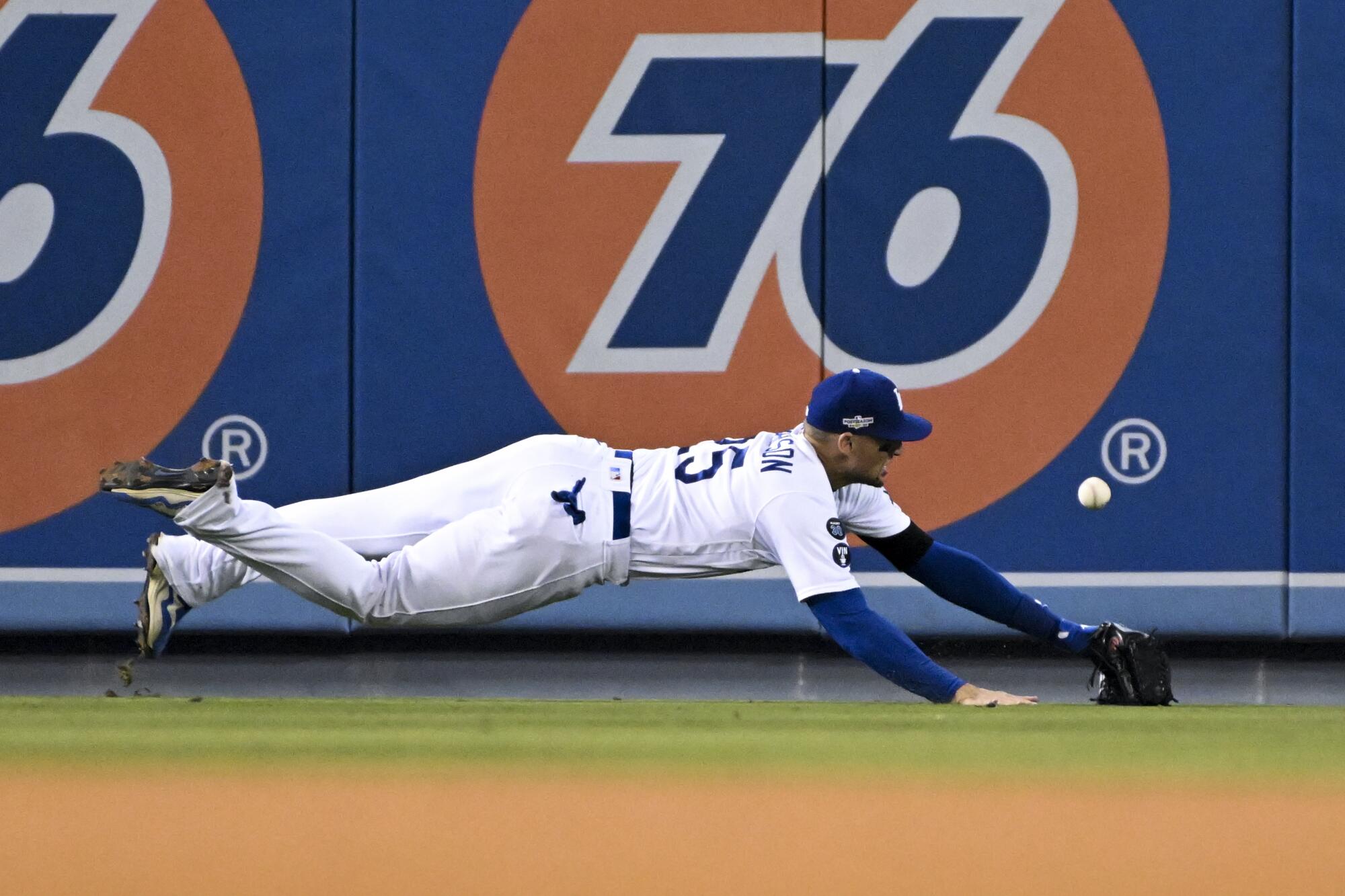 Dodgers left fielder Trayce Thompson dives for a ball.