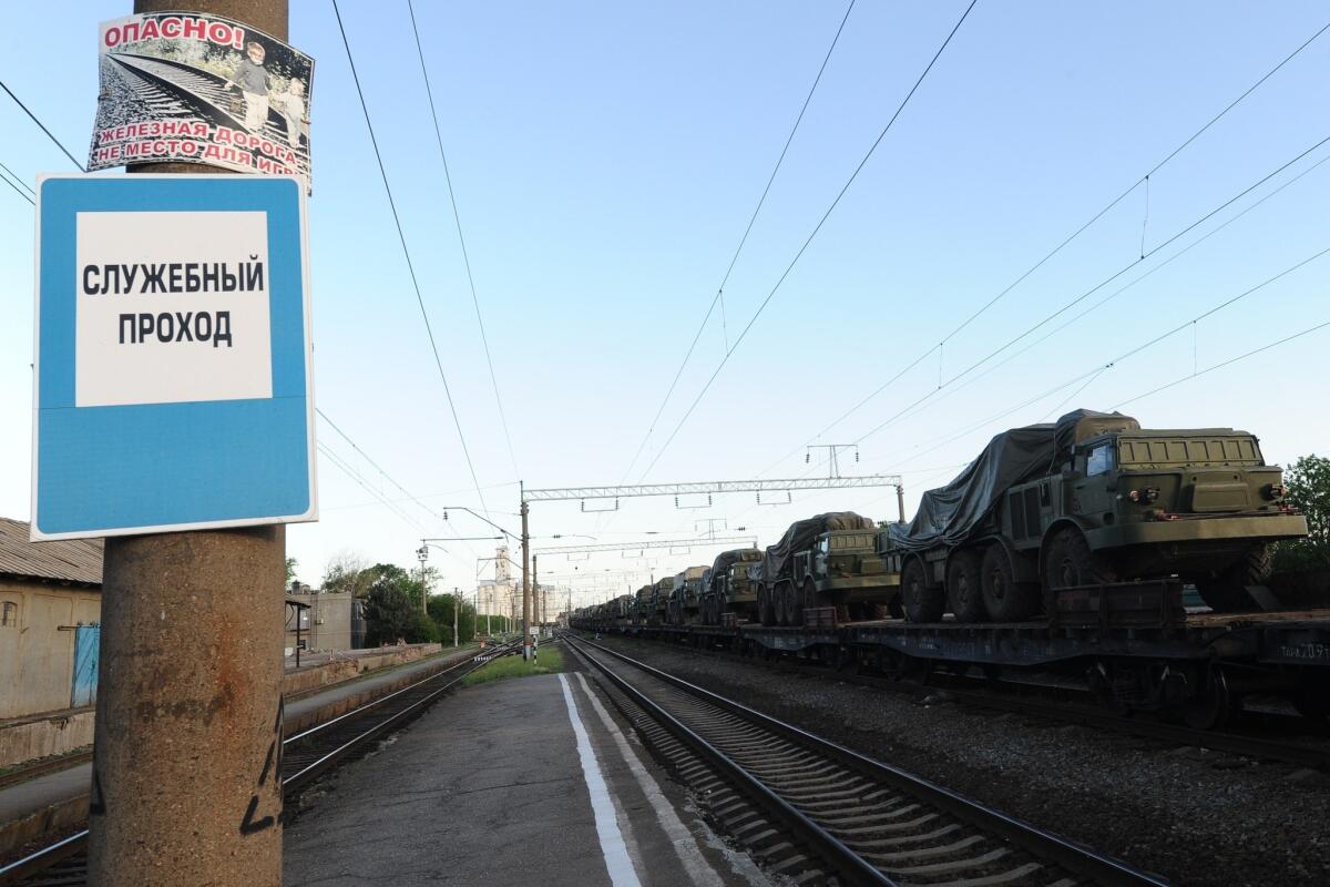 Russian armored vehicles are readied May 23 for transport on a freight train from the town of Matveev Kurgan, 13 miles from the Ukrainian border.