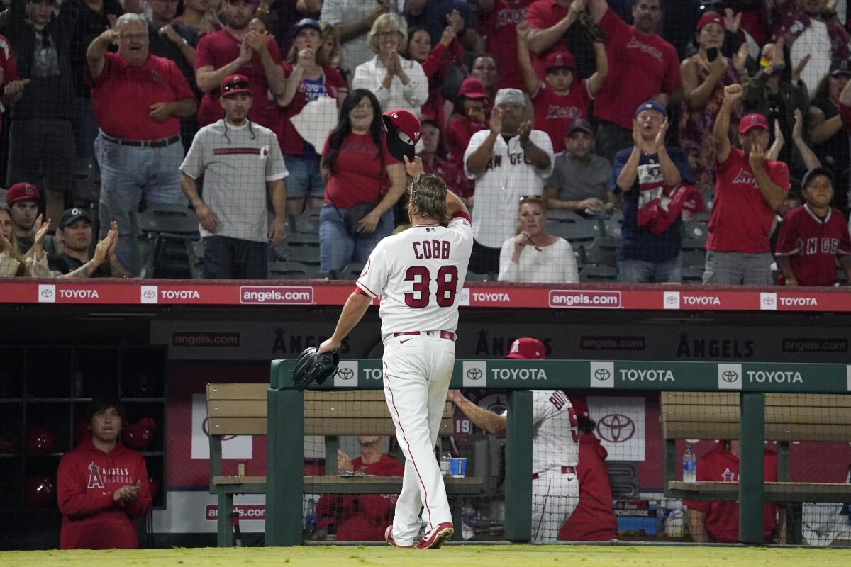 Angels starting pitcher Alex Cobb acknowledges a standing ovation he receives from the crowd.