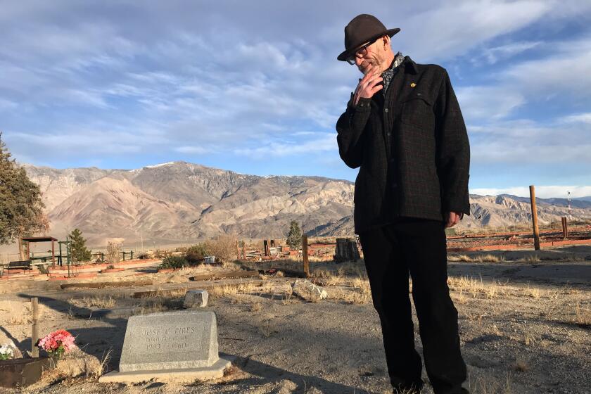 LONE PINA CA DECEMBER 18, 2019 -- Allen Berrey visits the grave site of Jose C. Pires, a.k.a. Portagee Joe, at Mt. Whitney Cemetery in Lone Pine. (Louis Sahagun / Los Angeles Times)