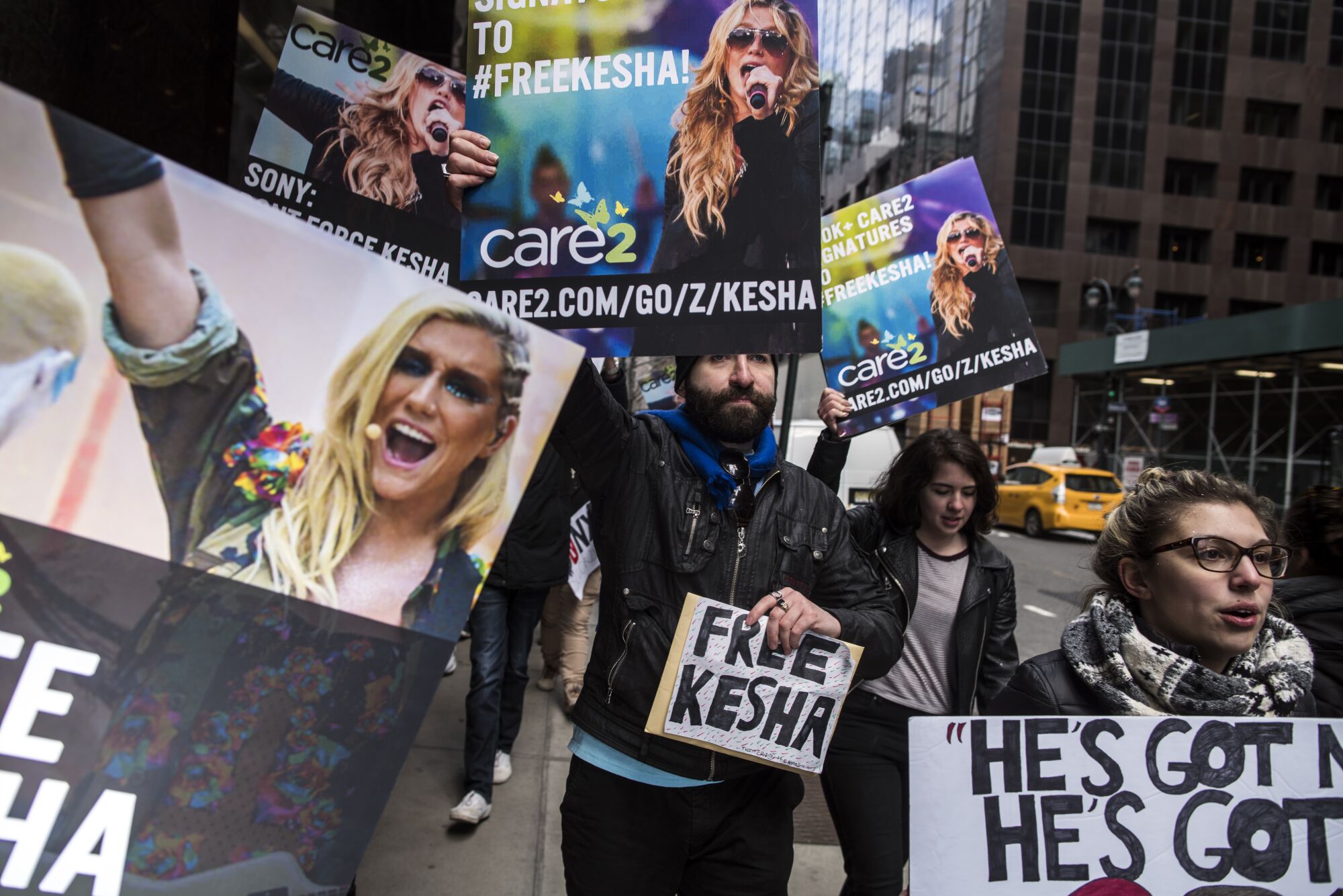 Supporters of singer Kesha gather in front of Sony headquarters in New York.