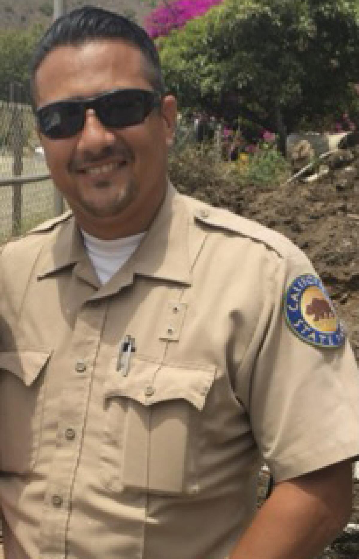 A man in sunglasses. wears a California State Parks uniform. 
