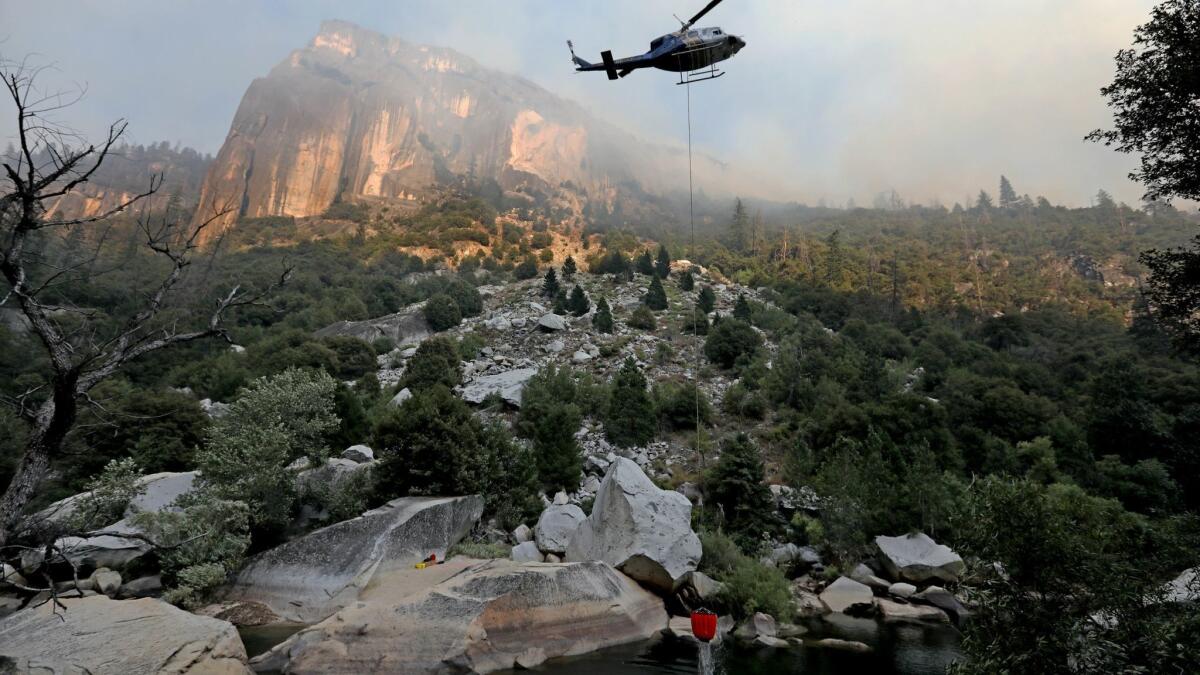 Helicopter crews work to stamp out the Ferguson fire as it burns along El Portal Road, a key entryway into Yosemite Valley.