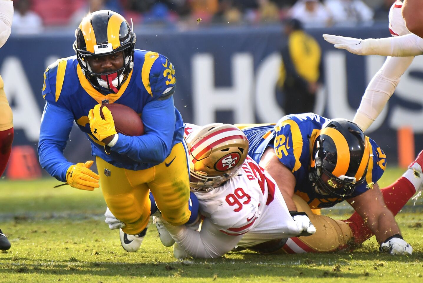 Rams running back C.J. Anderson is tackled by 49ers defensive lineman DeForest Buckner.
