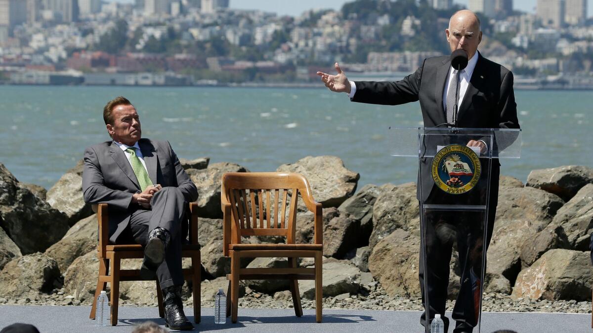 California Gov. Jerry Brown speaks as former Gov. Arnold Schwarzenegger, left, listens before a climate bill signing on Treasure Island in San Francisco on July 25.