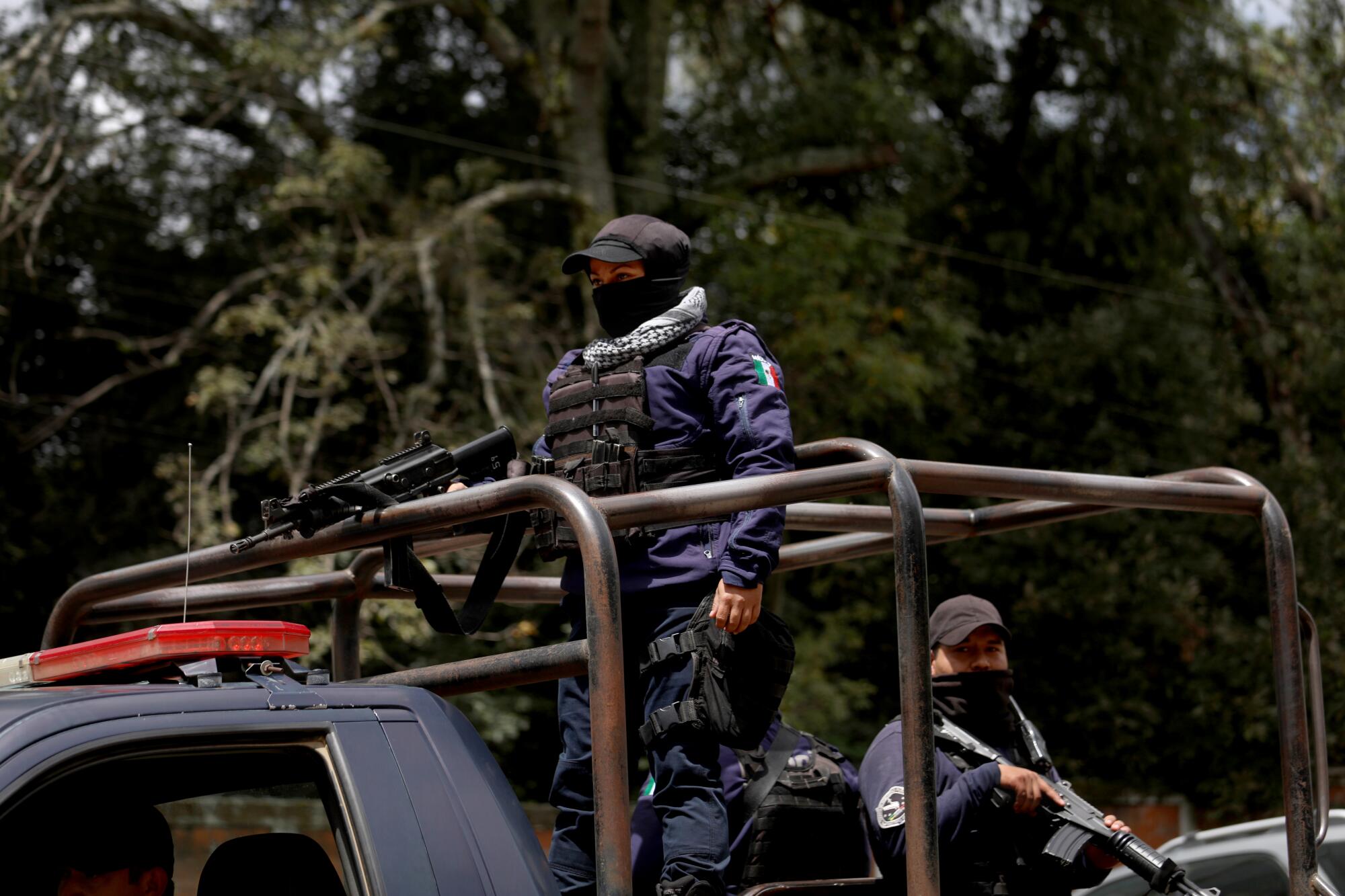 Members of an armed police force patrol in Tancitaro, Mexico.