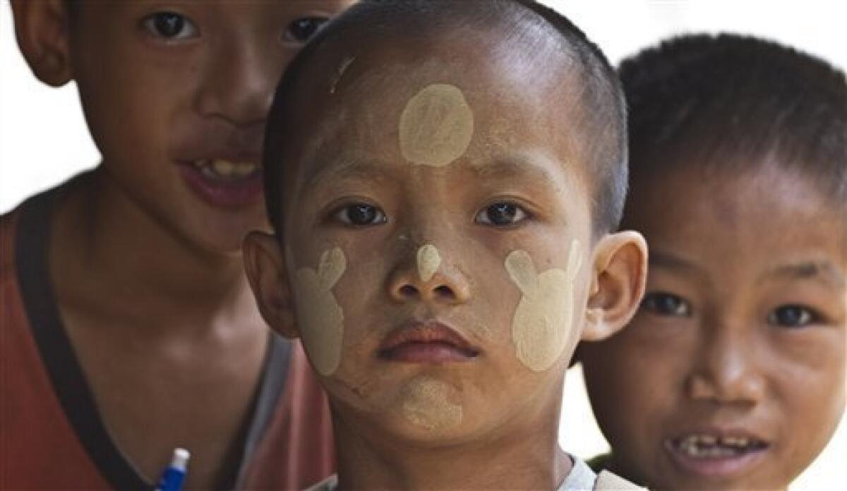 In this photo taken Tuesday, June 29, 2010, ethnic Karen children, their faces covered in Thanaka, a form of sunscreen, look on from Mae La Refugee Camp in western Thailand. The Karen, an ethnic minority people of about 4 million within Myanmar's 43 million, are being pushed by the military from their homes in western Myanmar to the border with Thailand almost daily. Human rights groups and aid workers call it "the hidden Darfur." (AP Photo/David Longstreath)