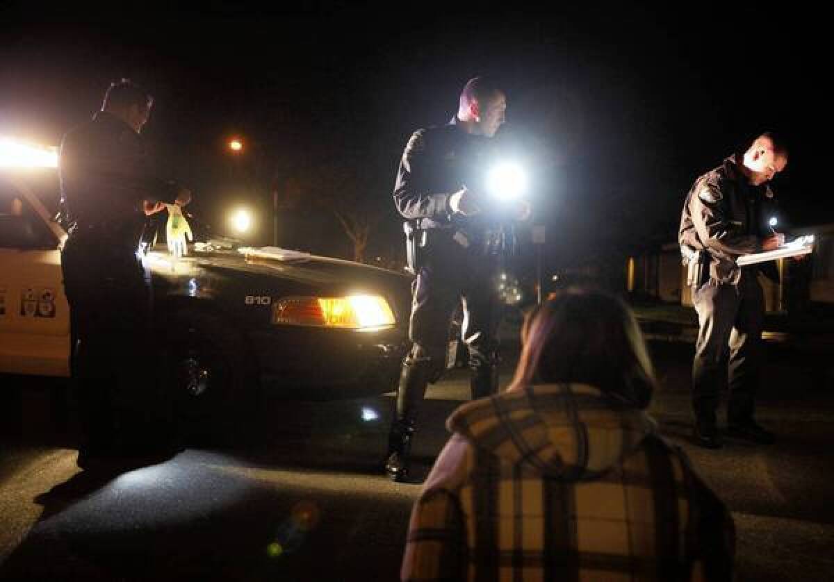 Huntington Beach police officers during a DUI investigation in 2011. The Orange County Crime Lab has found inaccurate test results in more than 2,200 DUI cases.