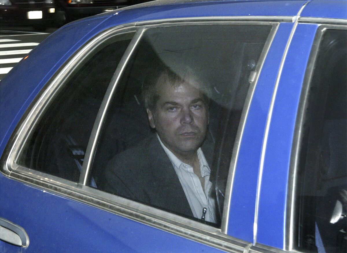 John Hinckley Jr. in the backseat of a car