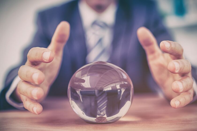 man looking into crystal ball to predict future