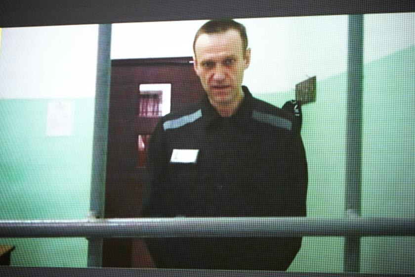 FILE - Russian opposition leader Alexei Navalny is seen on a TV screen as he appears in a video link provided by the Russian Federal Penitentiary Service from the colony in Melekhovo, Vladimir region, during a hearing at the Russian Supreme Court in Moscow, Russia, on June 22, 2023. The Kremlin on Tuesday Dec. 12, 2023 bristled at the U.S. voicing concern about Navalny who has vanished from his prison colony, denouncing it as “inadmissible interference” in the country's domestic affairs. Worries about Navalny, who has been serving a 19-year term on charges of extremism in a penal colony in western Russia spread Monday after prison officials said he was no longer on the inmate roster, possibly indicating his transfer to another penitentiary. (AP Photo/Alexander Zemlianichenko, File)