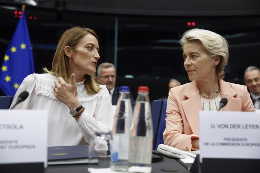 European Parliament President Roberta Metsola, left, and European Commission President Ursula von der Leyen, right, talk prior to the start of a session at the European Parliament, Tuesday, Sept. 17, 2024 in Strasbourg. (AP Photo/Jean-Francois Badias)