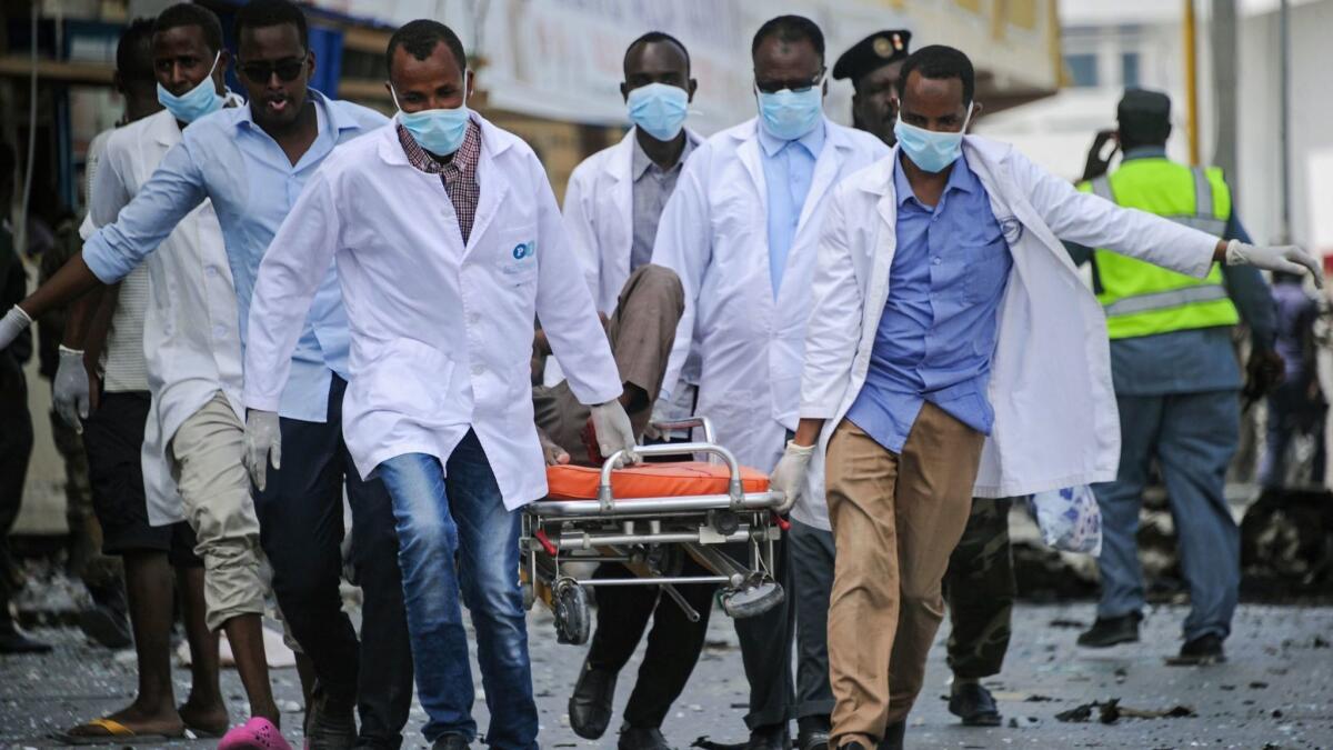 Paramedics carry a body away from the scene of Saturday's attack in Mogadishu.