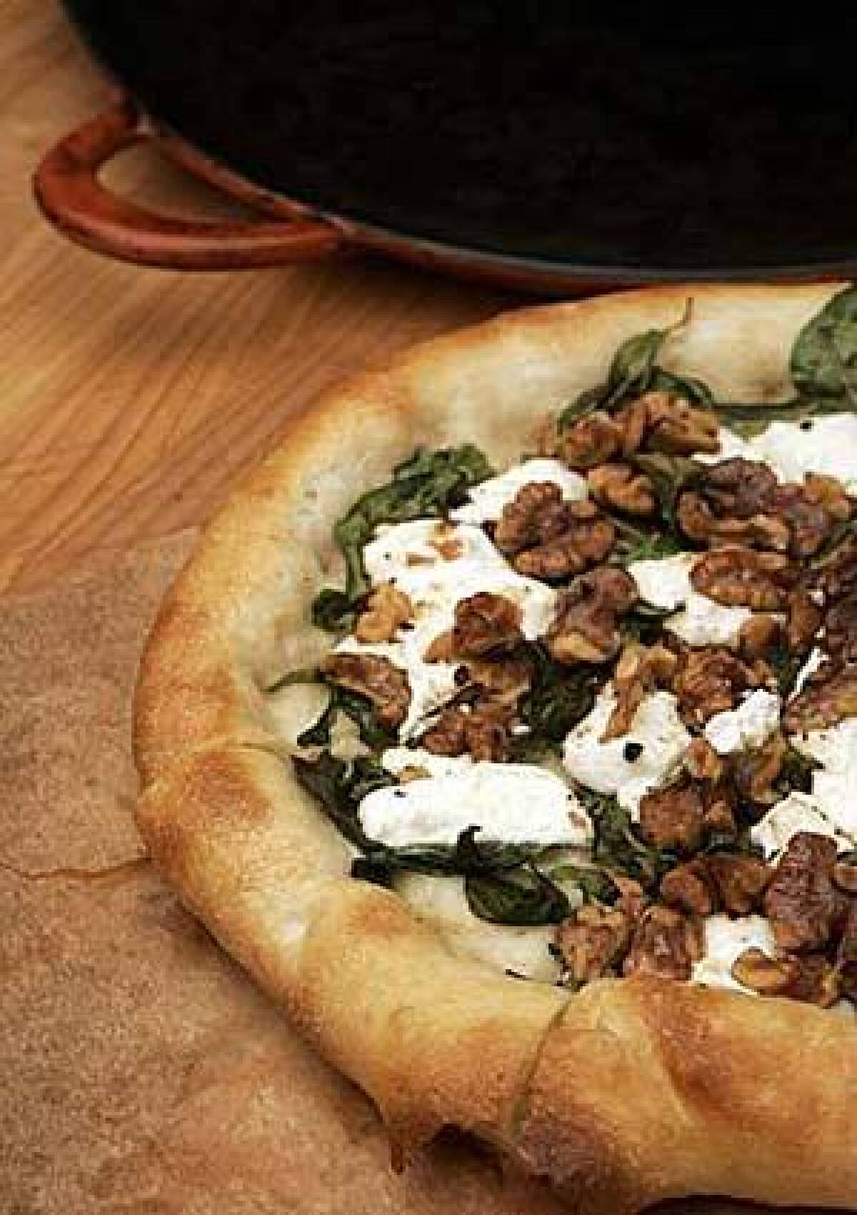 The nonbreakable (whew!) Batali pizza pan trumps stone. Use it to toast walnuts for a goat cheese-arugula pizza.