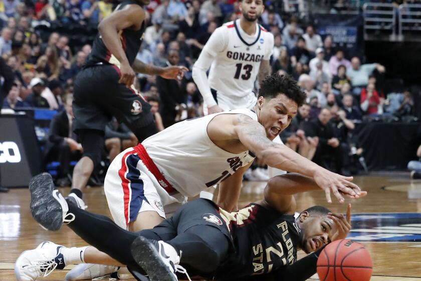 ANAHEIM, CALIF. - MAR. 28, 2019. Gonzaga forward Brandon Clarke fights for control ofm the ball against Florida State guard M.J. Walker in the second half of the NCAA Basketball West Regionals at the Honda Center in Anaheim on Thursday, Mar. 28, 2018. (Luis Sinco/Los Angeles Times)