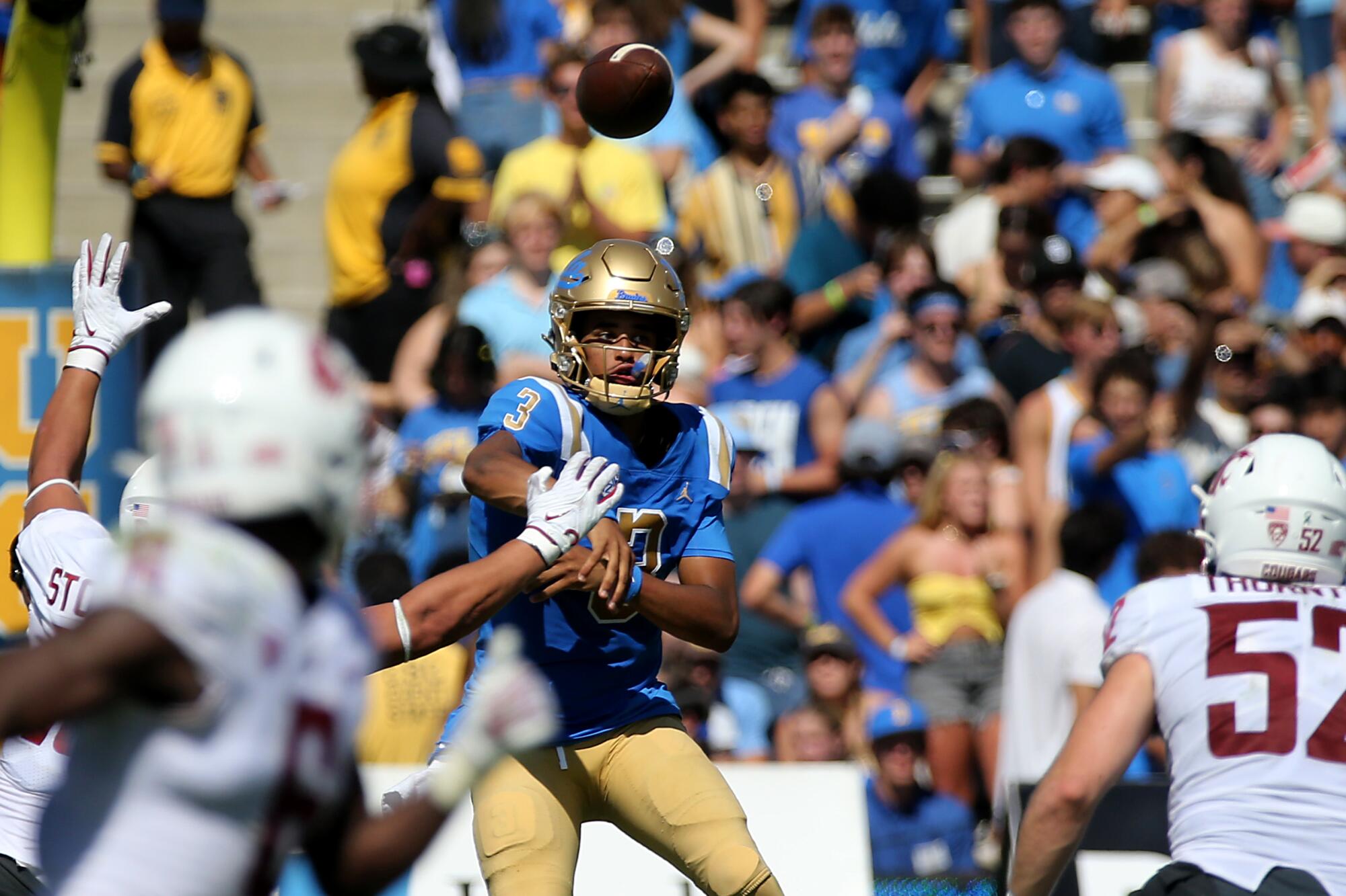 UCLA quarterback Dante Moore throws downfield against Washington State.
