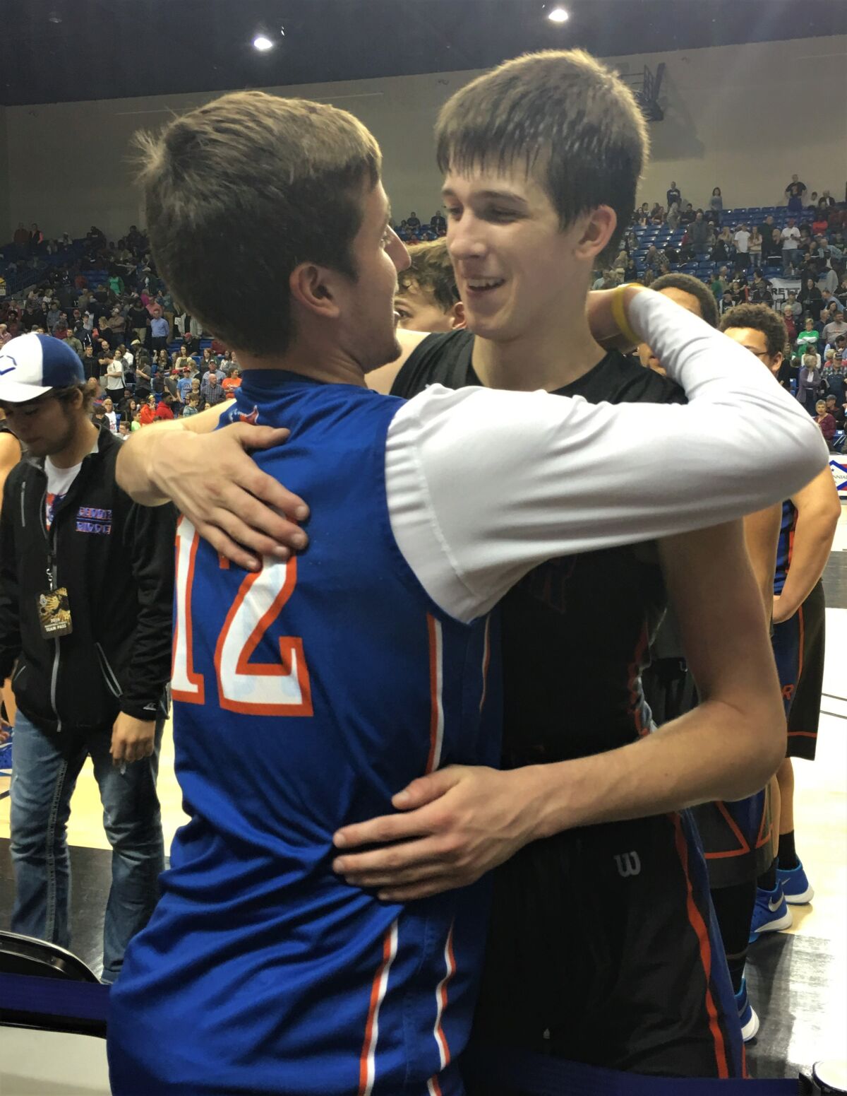 Austin Reaves is hugged by his older brother Spencer after a Cedar Ridge High game.