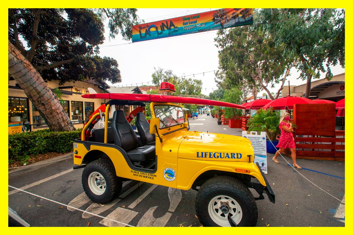 A classic lifeguard jeep helps block off the street for foot traffic only on Forest Ave. in Laguna Beach.