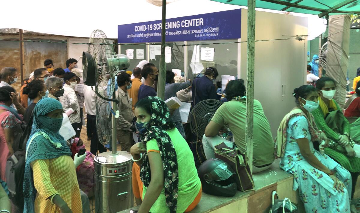 People wait in line to be tested for COVID-19 at a hospital in New Delhi on June 20.