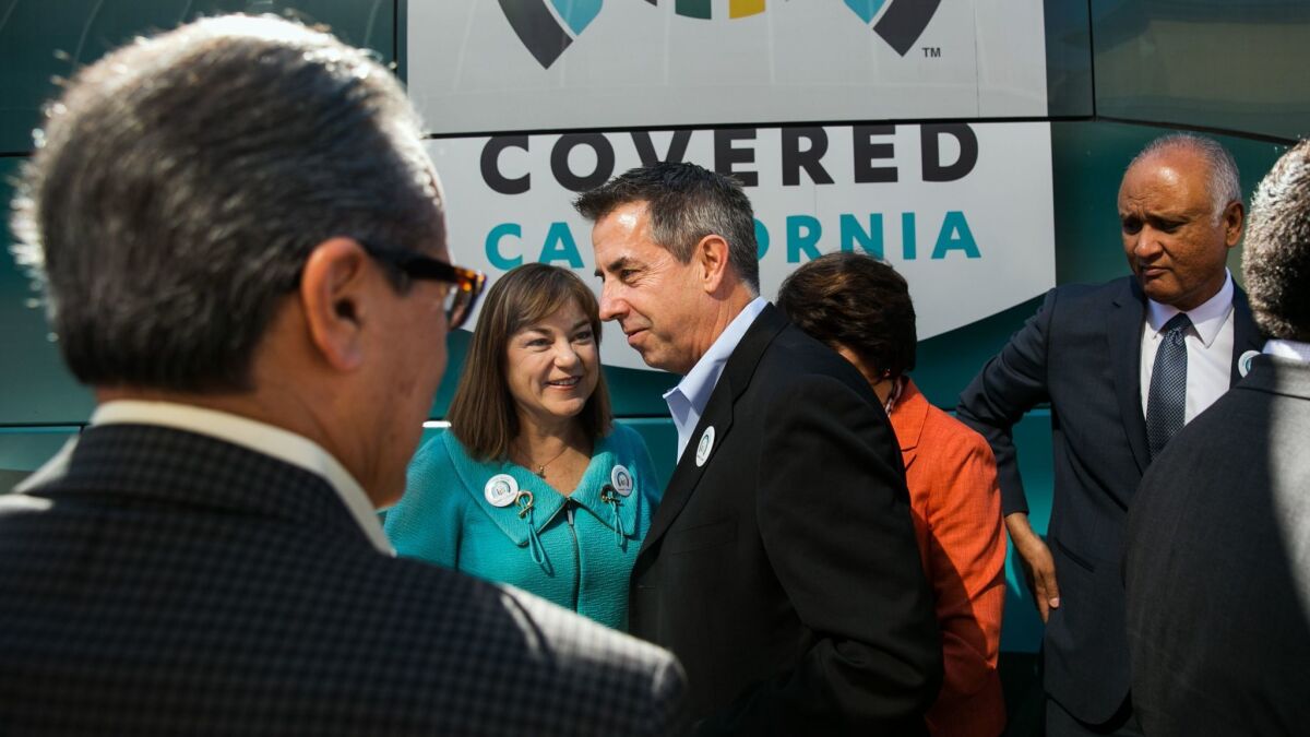Covered California Executive Director Peter V. Lee, center, mingled with federal lawmakers and others during the launch of open enrollment for Obamacare health plans in 2015.