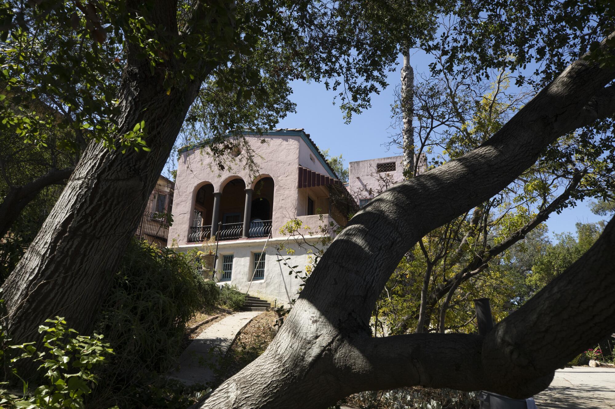  Villa Capistrano in Silver Lake seen between the branches of a tree.