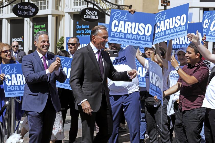 LOS ANGELES, CA - MAY 12, 2022 - - Los Angeles City Councilman Joe Buscaino, left, and businessman Rick Caruso greet supporters where Buscaino announces that he's dropping out of Los Angeles mayoral race and putting his support behind Caruso for mayor of Los Angeles at The Grove in Los Angeles on May 12, 2022. (Genaro Molina / Los Angeles Times)