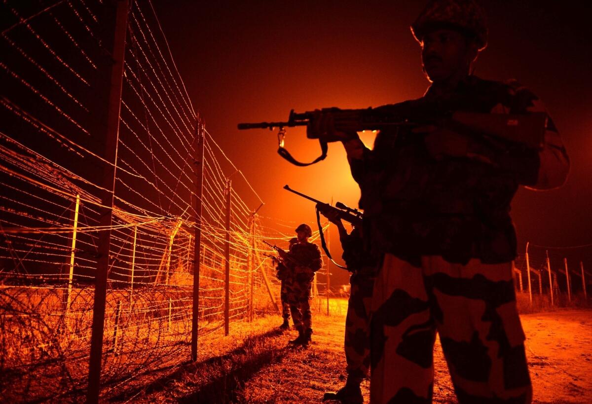 Indian Border Security Force soldiers go on patrol at an outpost along the India-Pakistan border.
