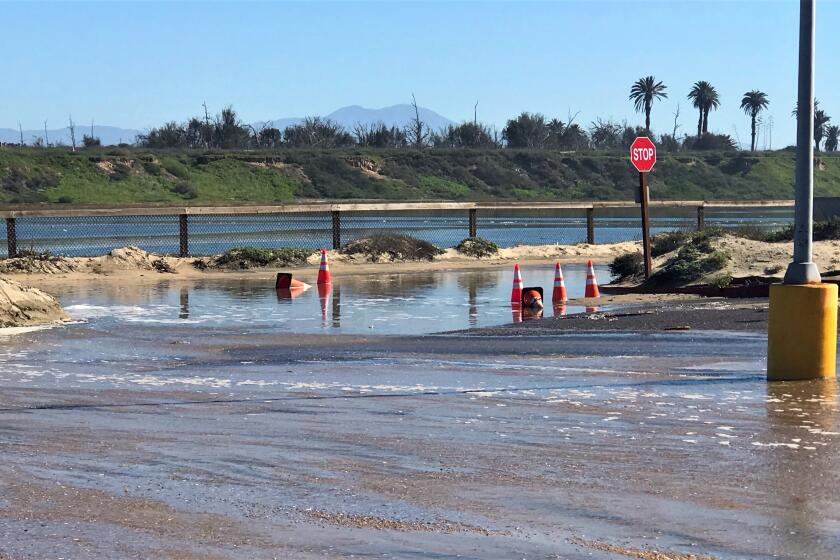 A parking lot near Pacific Coast Highway in Huntington Beach was hit by a tidal surge Tuesday that closed the highway. 