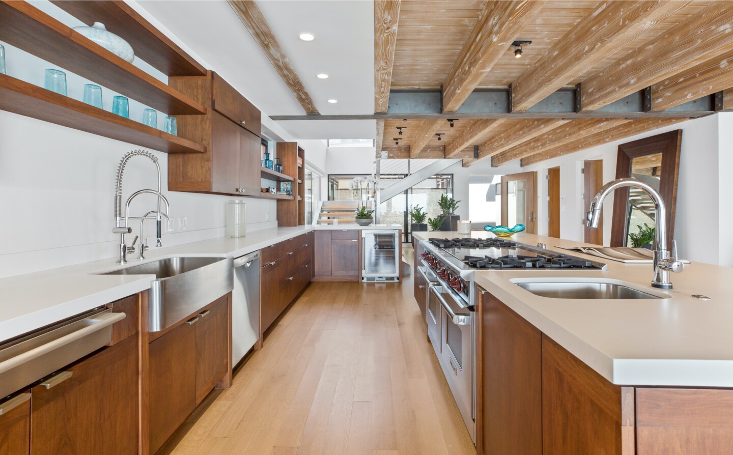 The architectural beach house expands to two levels of wood decks overlooking the ocean.
