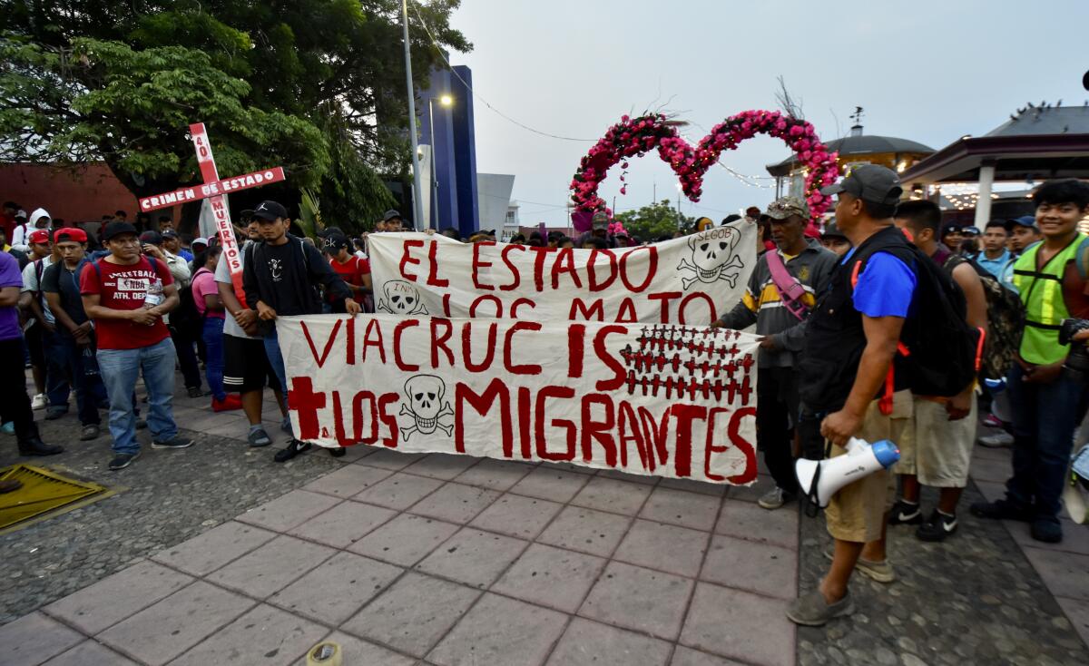 Migrants holding banners beginning a protest march across Mexico