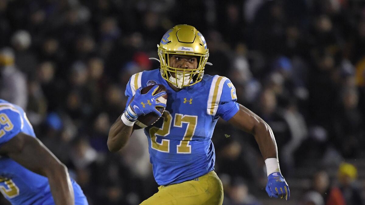 Former UCLA running back Joshua Kelley runs the ball