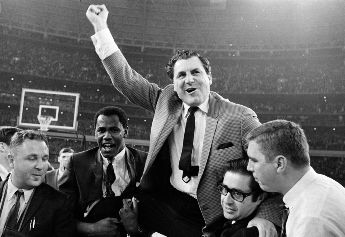 Houston coach Guy V. Lewis is carried to the dressing room after the Cougars' win over UCLA at the Astrodome in Houston on Jan. 20, 1968.