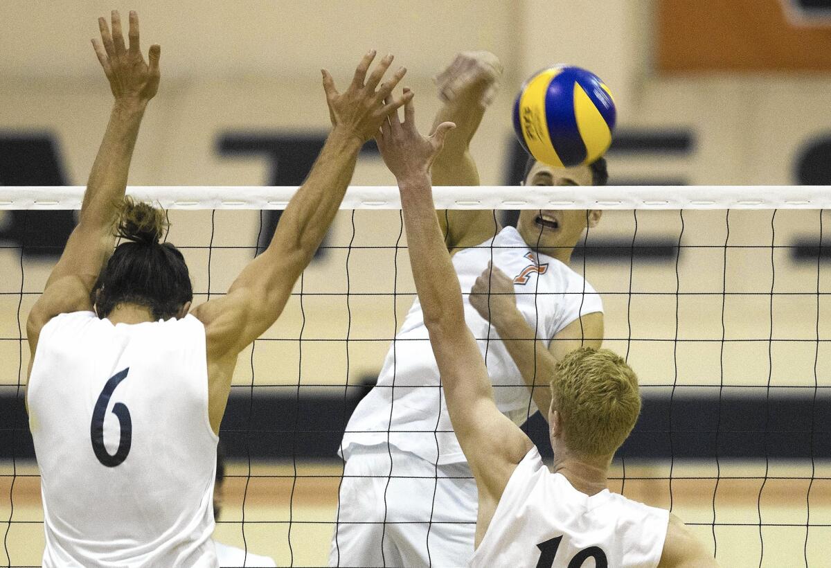 Orange Coast College's Matthew Ujkic, top right, scores during the first set against Irvine Valley. The match was later canceled due to a power outage during the first set.