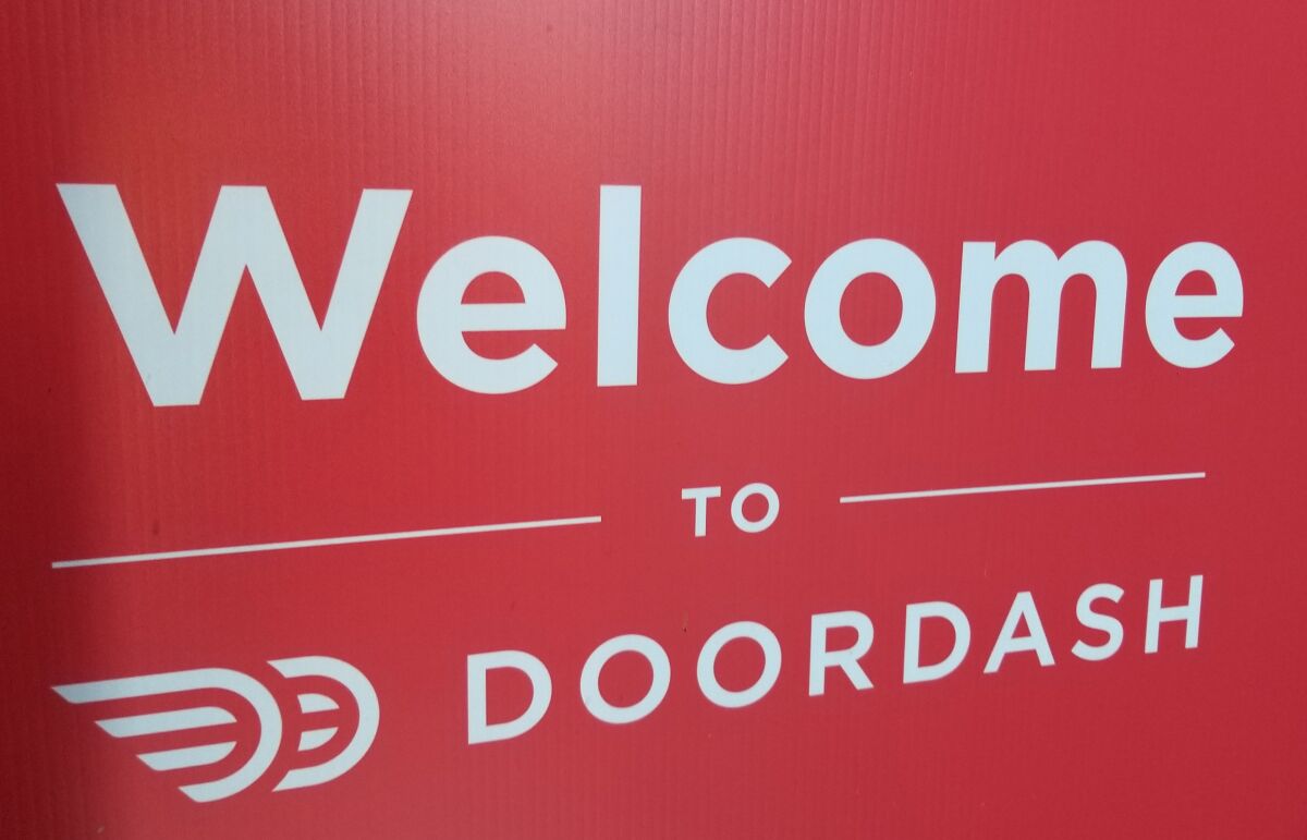 A red sign that says "Welcome to DoorDash."