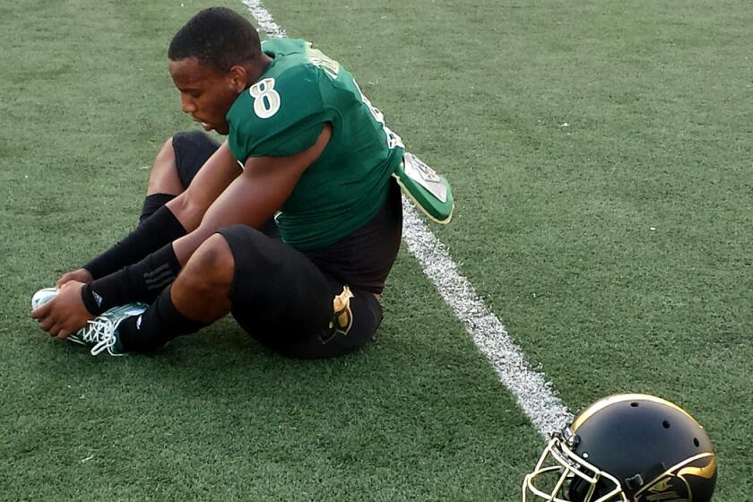 Long Beach Poly defensive back Iman Marshall stretches before a game last September. He has signed to play for USC.
