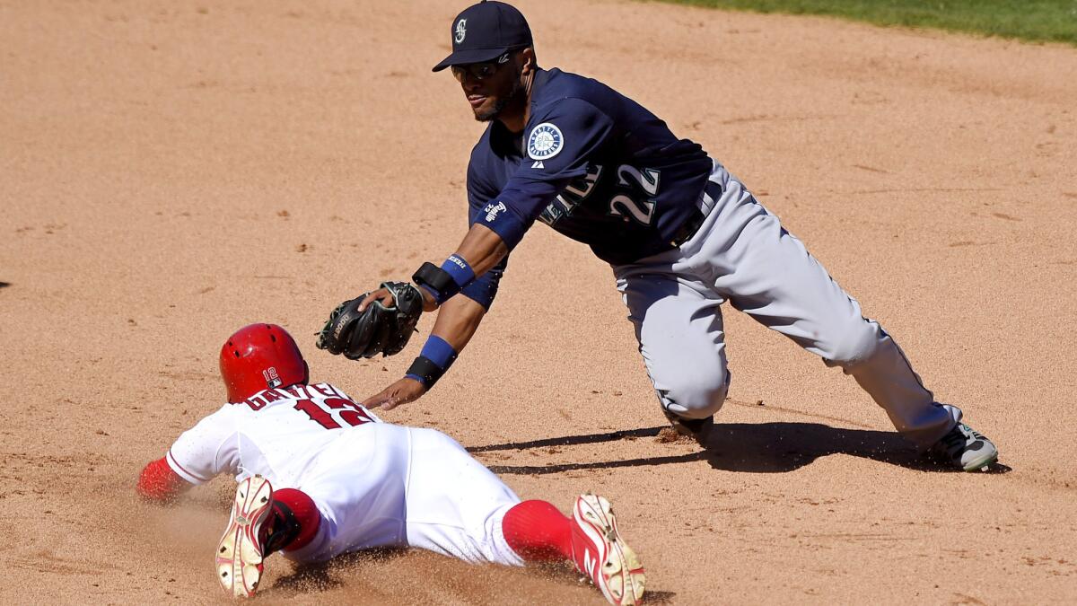 Angels second baseman Johnny Giavotella slides safely into second base with a double against Mariners second baseman Robinson Cano for a double in the eighth inning Saturday afternoon.