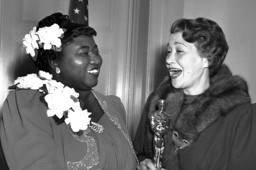 FILE - Actor Fay Bainter, right, appears with actor Hattie McDaniel the night McDaniel won best supporting actress for her role in the 1939 film “Gone With the Wind” in Los Angeles on Feb. 29, 1940. McDaniel received a plaque, not an Oscar statuette, as was the custom for supporting actor winners of that era. The Academy of Motion Pictures Arts and Sciences has created a replacement of McDaniel's Academy Award plaque that it is gifting to Howard University. (AP Photo, File)