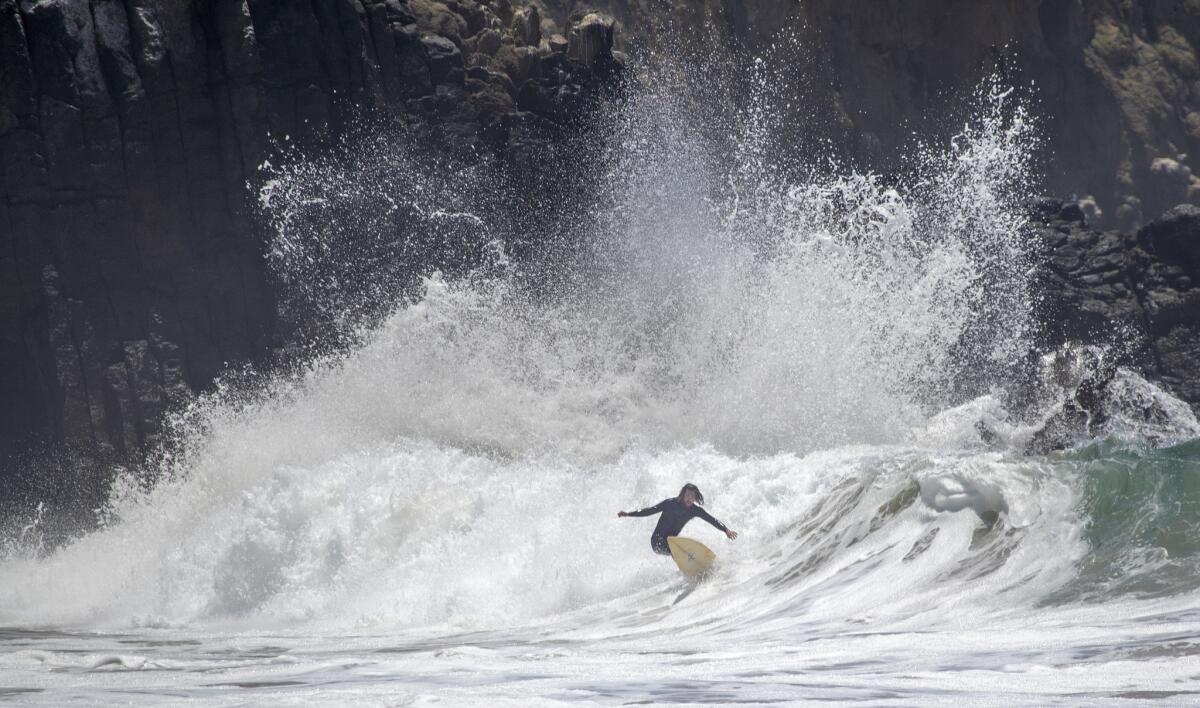 LAGUNA BEACH, CALIF. -- MONDAY, JUNE 11, 2018: A surfer rides a big wave at Crystal Cove State Park's Morro Beach in Laguna Beach, Calif., on June 11, 2018. Large waves and strong rip currents will continue through Tuesday at south-facing beaches. (Allen J. Schaben / Los Angeles Times)