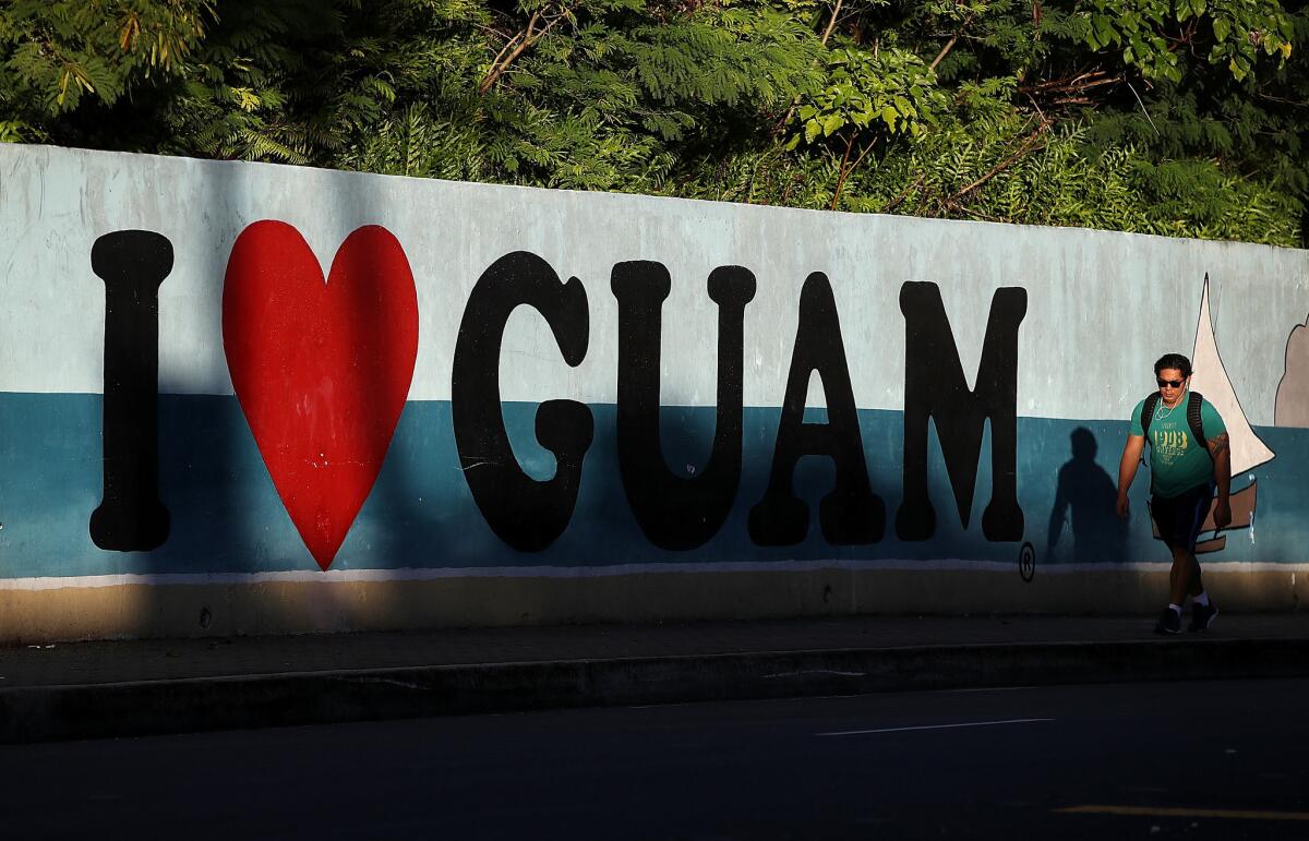 A pedestrian walks by a mural in Tamuning, Guam. The American territory of Guam remains on high alert as a showdown between the U.S. and North Korea continues.