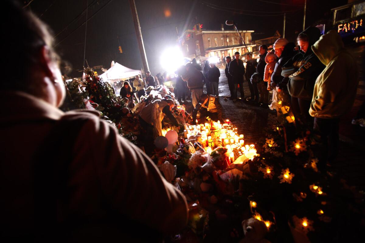 People continue to flock to a makeshift memorial to pay their respects to those who died in the Sandy Hook Elementary School shooting.