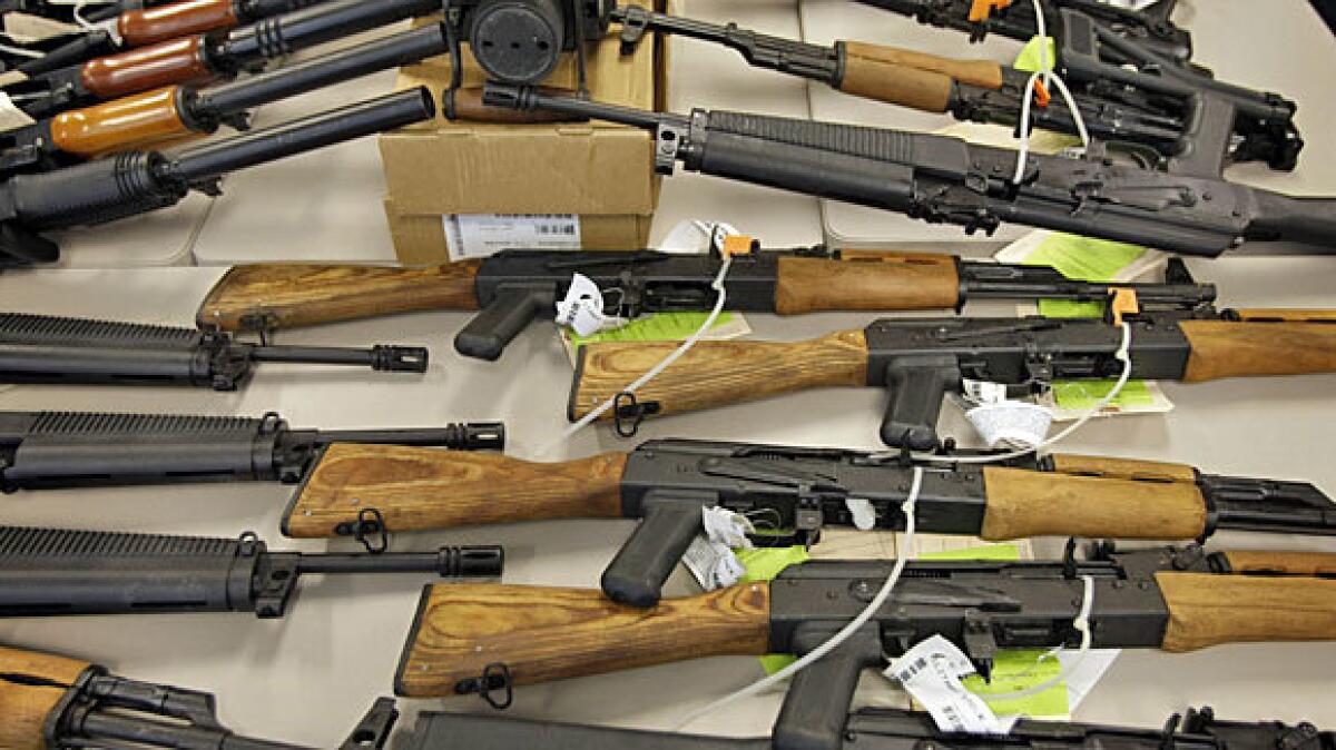 Part of a cache of seized weapons is displayed at a news conference early this year in Phoenix.