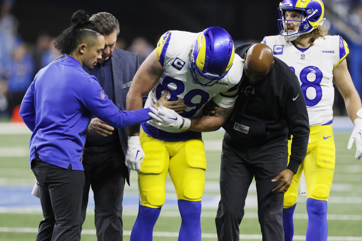 Rams tight end Tyler Higbee is helped off the field after sustaining a knee injury against the Detroit Lions.