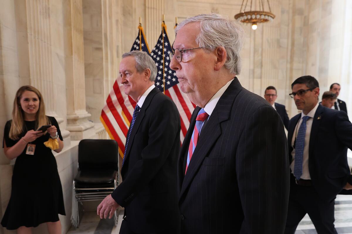 Senate Minority Leader Mitch McConnell and Sen. Mike Crapo leave a Senate Republican Policy Committee closed-door luncheon.