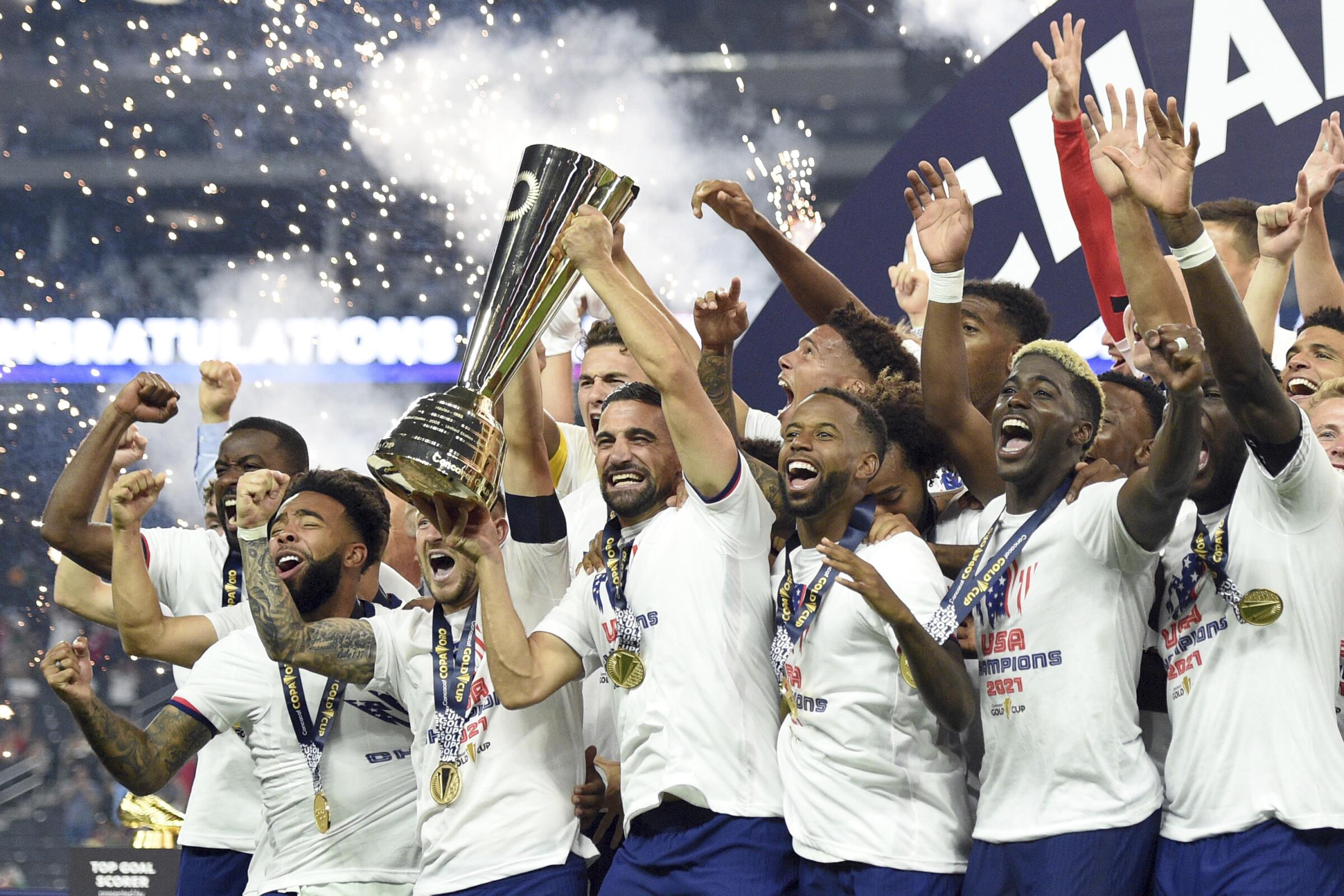 United States players celebrate their extra-time victory over Mexico in the CONCACAF Gold Cup final soccer.