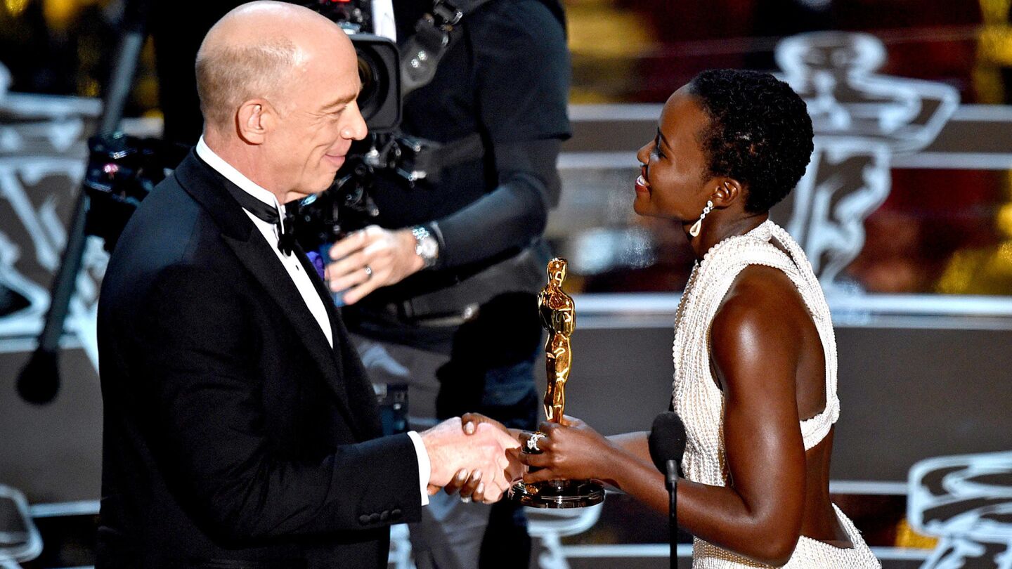 Lupita Nyong'o presents J.K. Simmons with the award for supporting actor for "Whiplash."